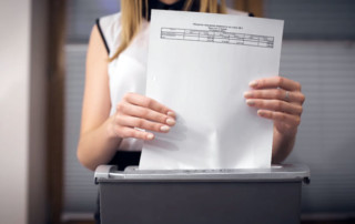 Woman putting a legal document through a shredding machine